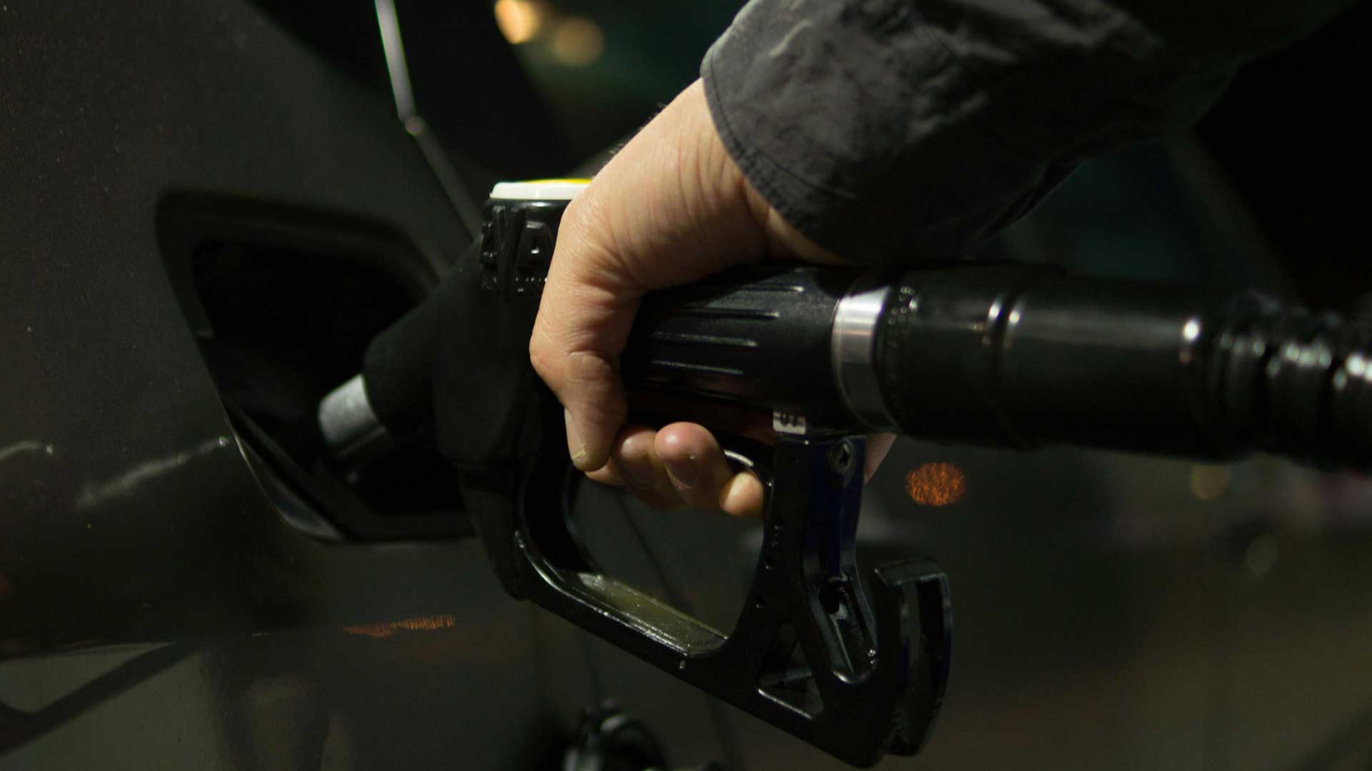 Person holding gasoline nozzle