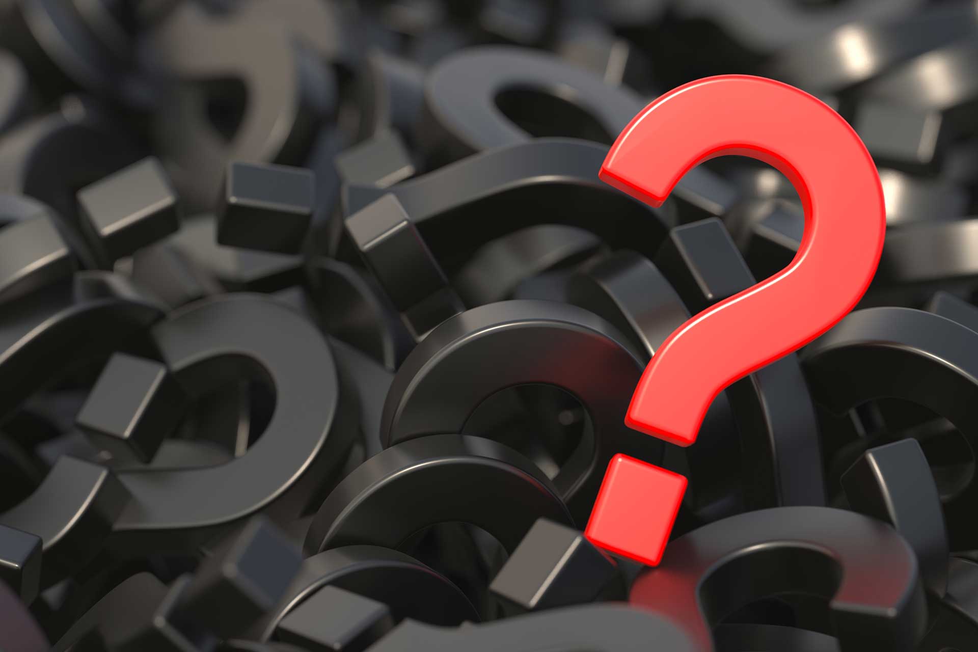 Red question mark on a pile of black question marks