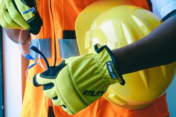 PPE including safety vest, helmet, gloves, and eye protection.
