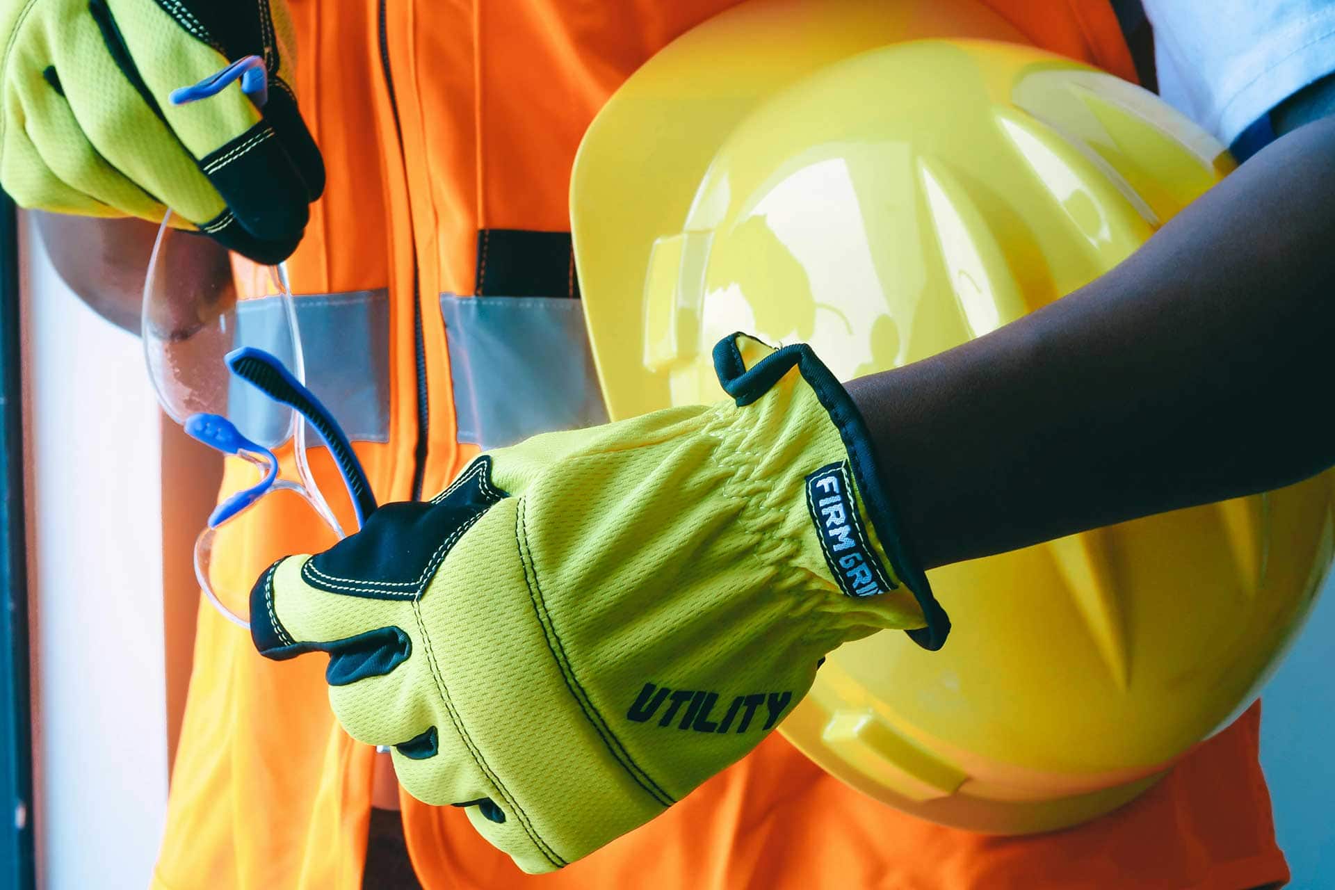 PPE including safety vest, helmet, gloves, and eye protection.